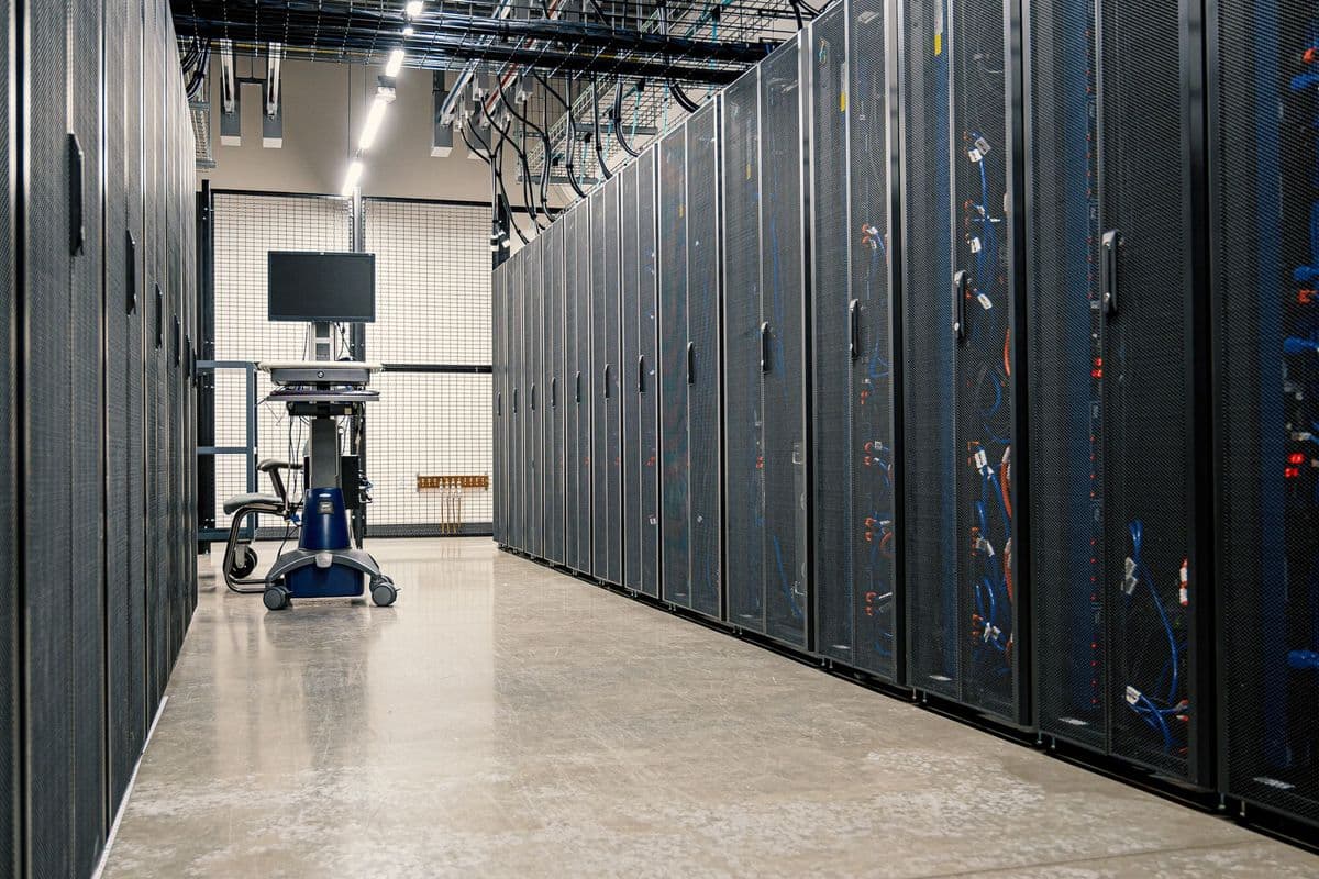 Steel framework cabinets housing servers networking devices and cables in contemporary equipped data center